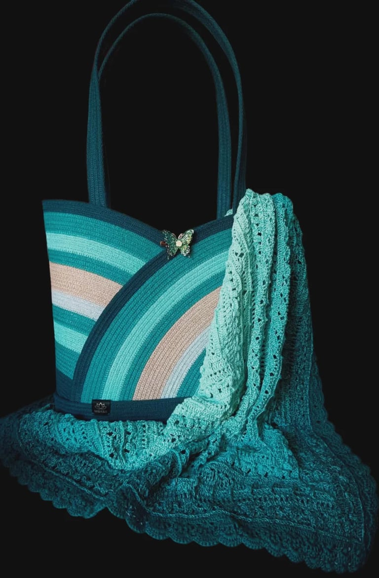 Teal and beige striped canvas tote bag with decorative lace scarf draped over it against a black background