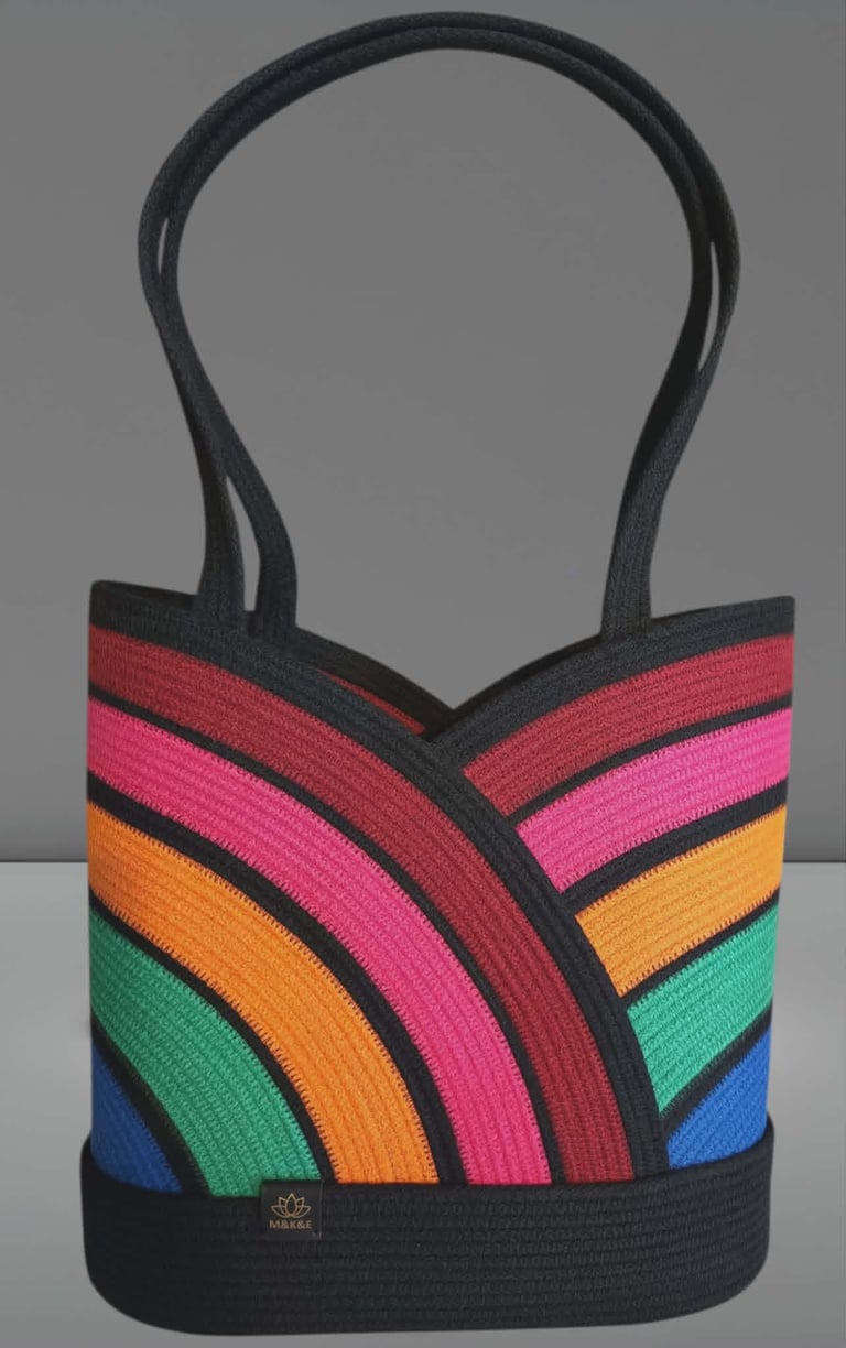 Rainbow striped tote bag with black handles and base, featuring concentric curved colored bands in red, pink, orange, green, and blue