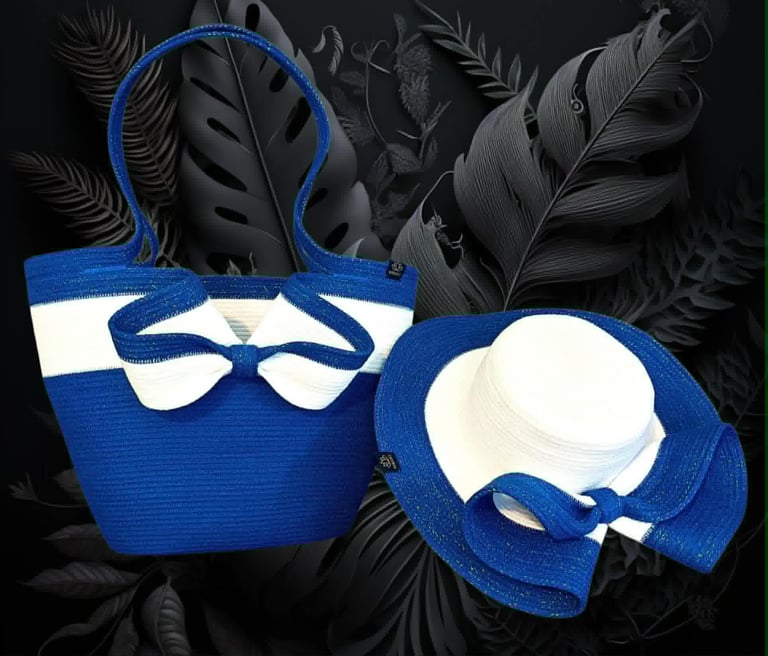 Blue tote bag and matching wide-brimmed hat with cream accents displayed against dark feathered background